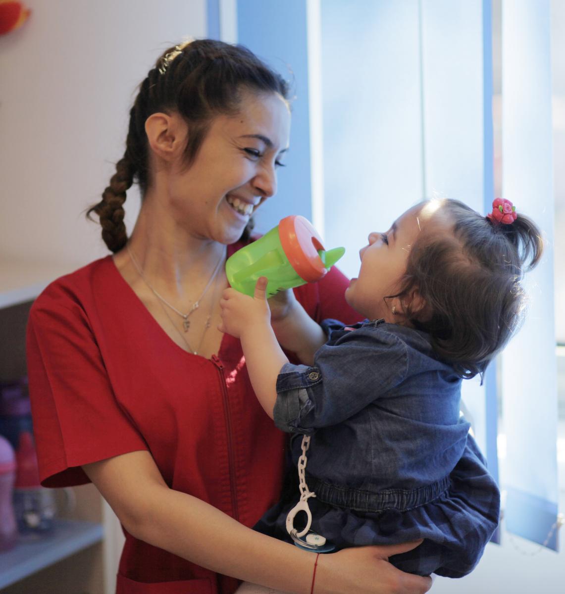 teacher smiles at girl